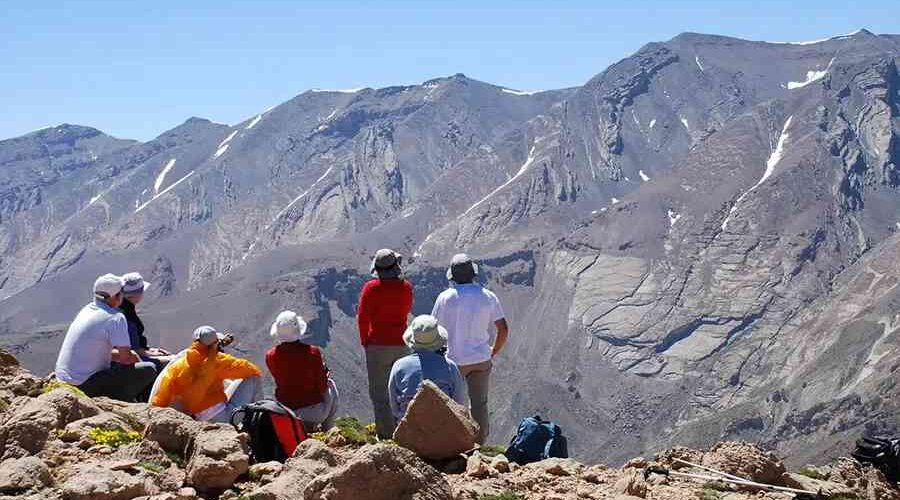 Hikers rest and enjoy panoramic views on a 3-Day Atlas Mountains trek.