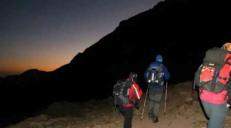 Trekkers on an early morning hike during the 4-Day Mount Toubkal Trek with sunrise.