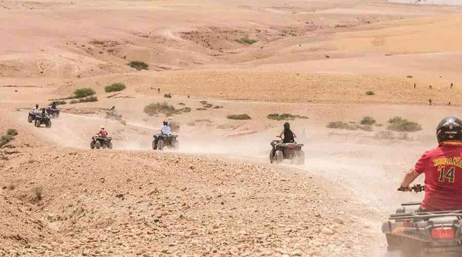 A group of quad bikers kicking up dust as they explore the expansive Agafay Desert.