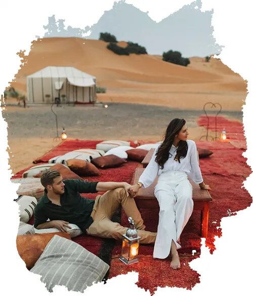 Couple in Merzouga luxury Sahara desert camp enjoying their Marrakech Sahara desert tour.
