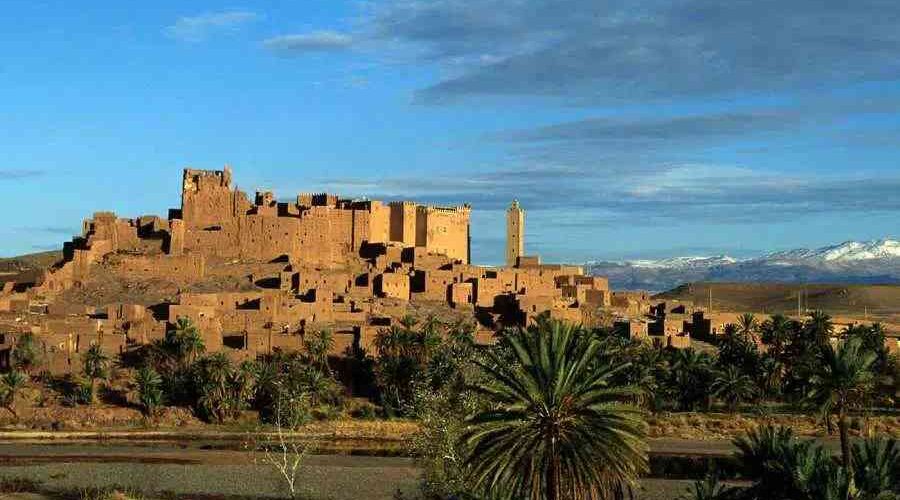 Kasbah Ait Ben Haddou with snowy Atlas Mountains in the background.