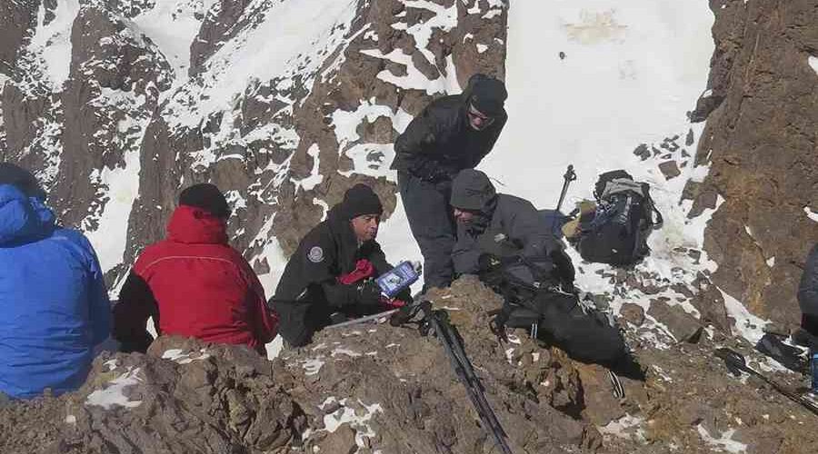 Trekking group on a snowy ledge during the 2-Day Mount Toubkal Trek.