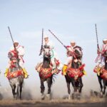5 Moroccan Fantazia show horsemen holding their artisanal arms