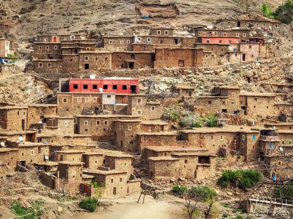 Traditional Berber village with earthen houses nestled in the Moroccan mountains.