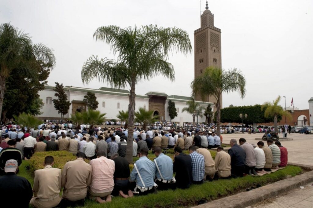 Moroccan praying outside a Mosque in Casablanca