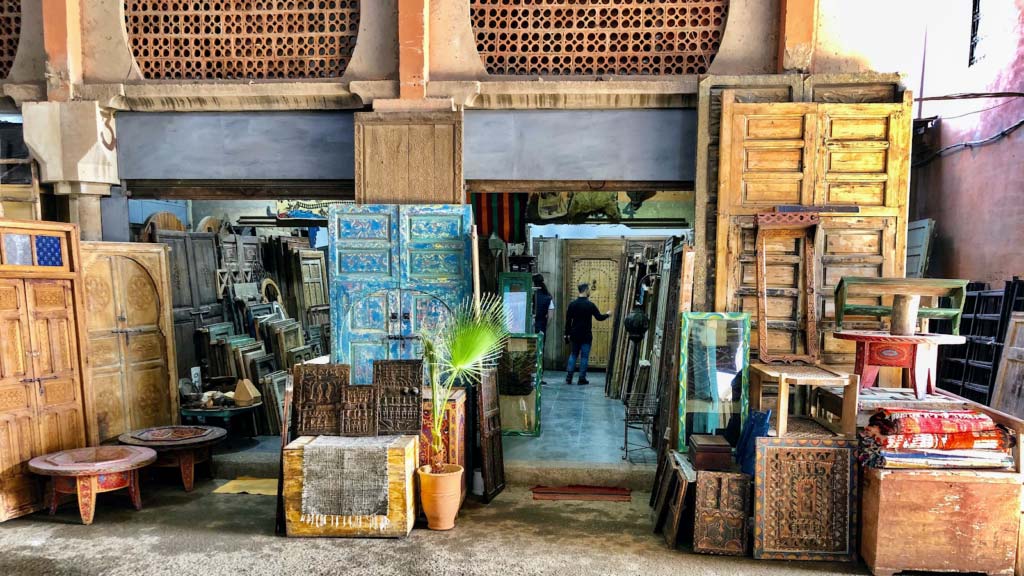 Assortment of antique doors and furniture for sale at Bab Lakhmis flea market in Marrakech.