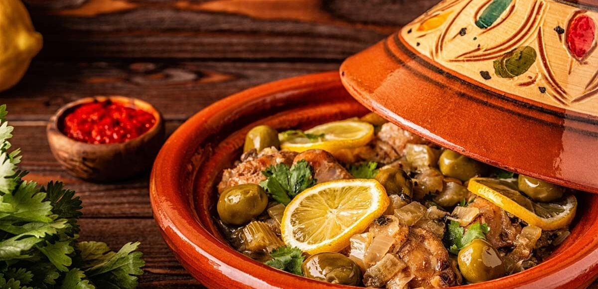 Moroccan chicken Tagine with olives, preserved lemons and a cup of Harissa sauce