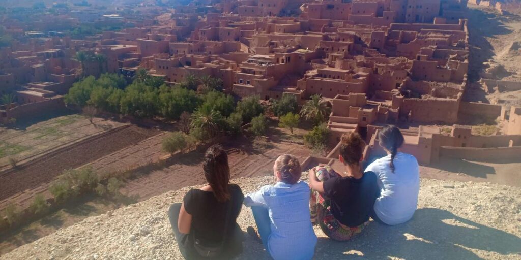 Tourists enjoying the view of Kasbah Ait Ben Haddou from above
