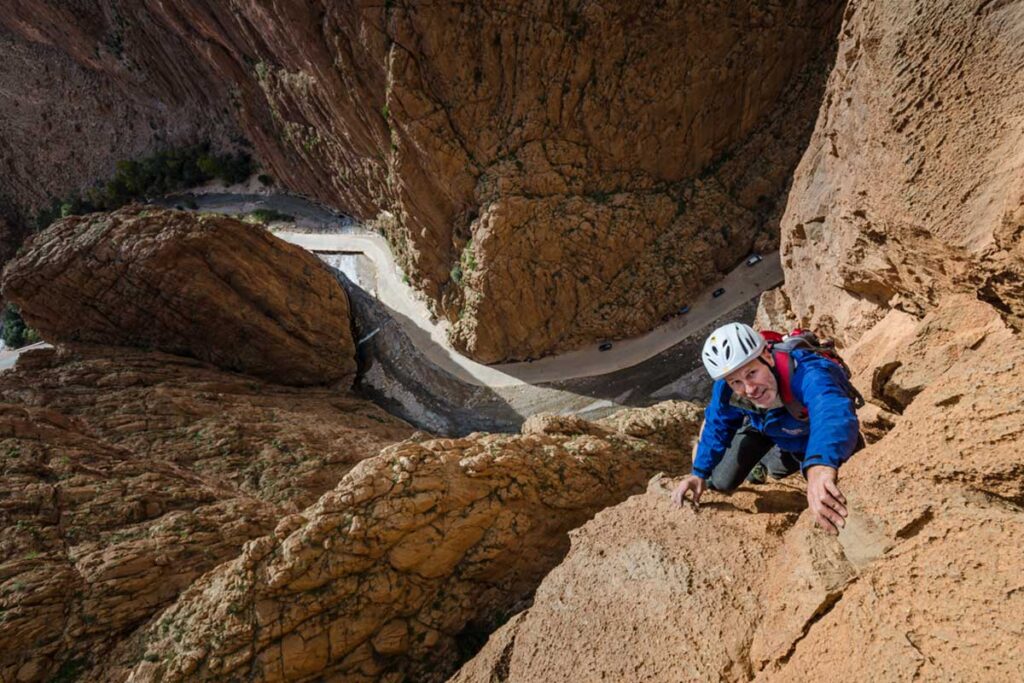 Climber tackles vertical limestone on classic multi-pitch route in Todra Gorge