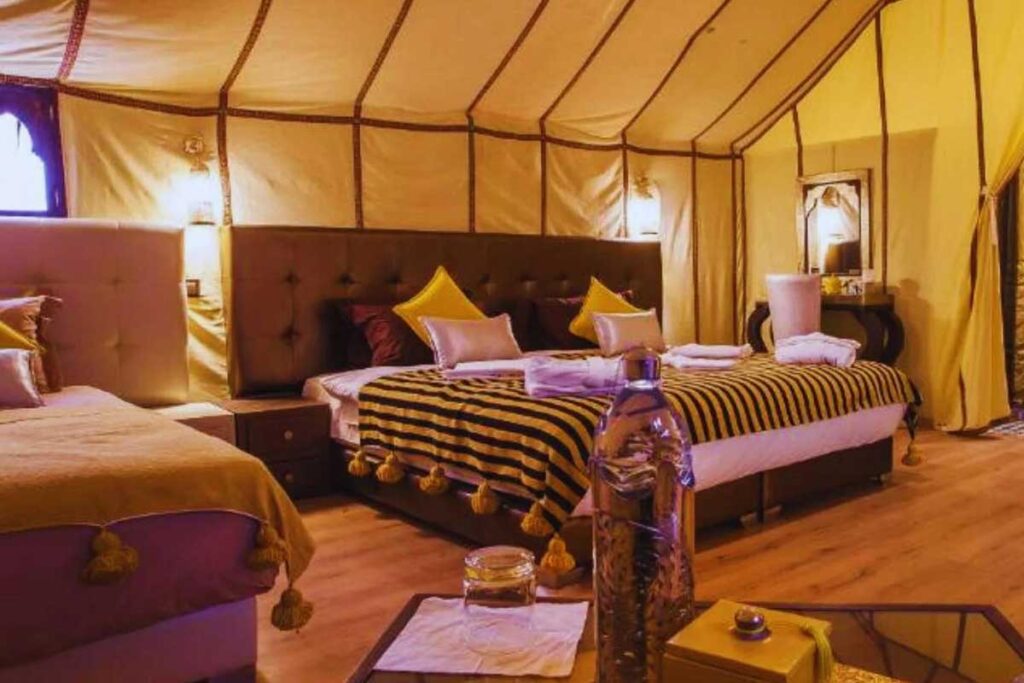 Luxury desert camp ensuite tent interior in Merzouga Sahara Desert Morocco.