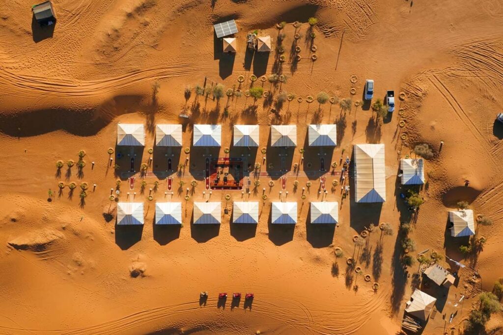 Aerial view of a luxury desert camp in Merzouga with private tents near the Erg Chebbi dunes
