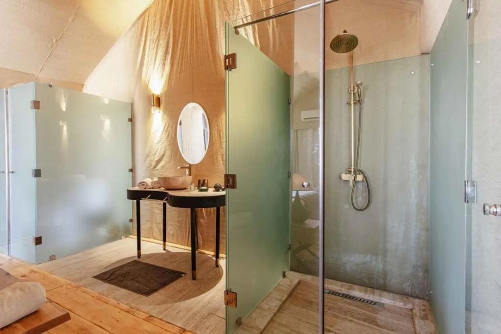 Ensuite private bathroom inside a luxury desert camp tent in Merzouga with shower and toilet