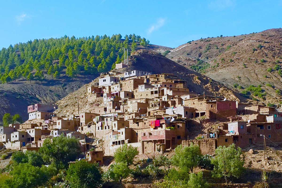 Traditional Berber village of mud-brick houses built into a hillside in the Ourika Valley, day trip from Marrakech